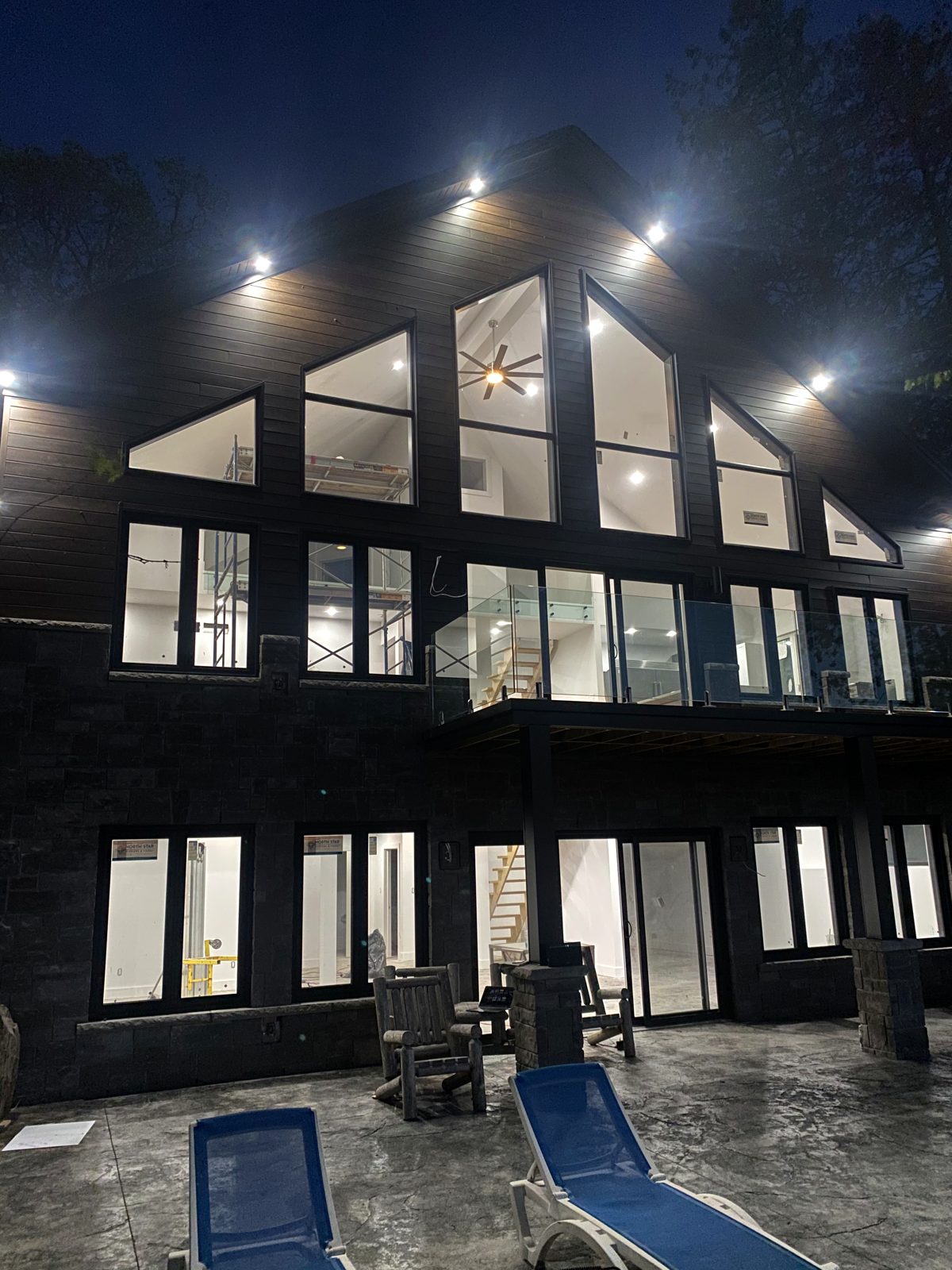 Finished lakeside home lit at dusk