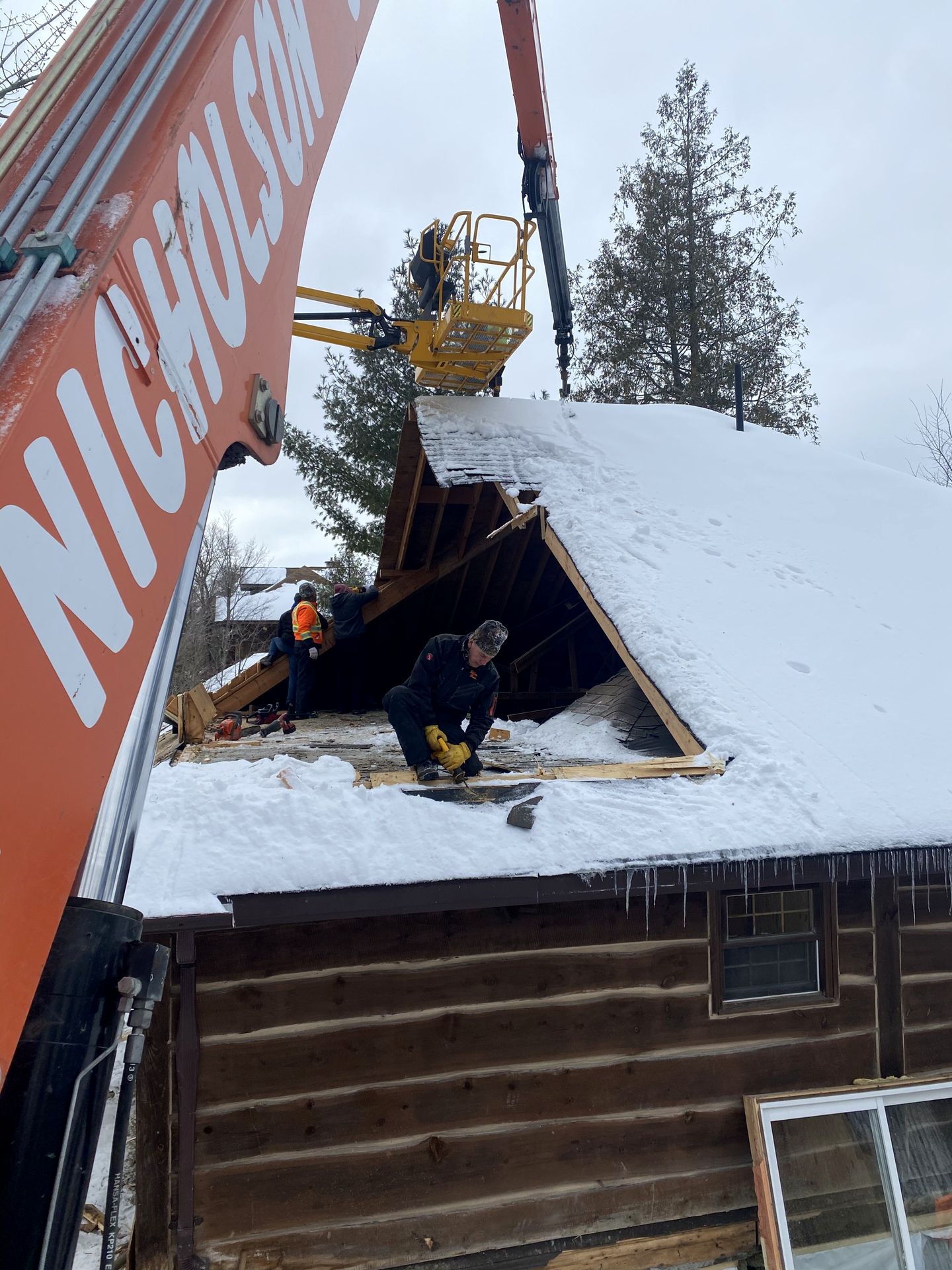 Taking down an old roof during a teardown